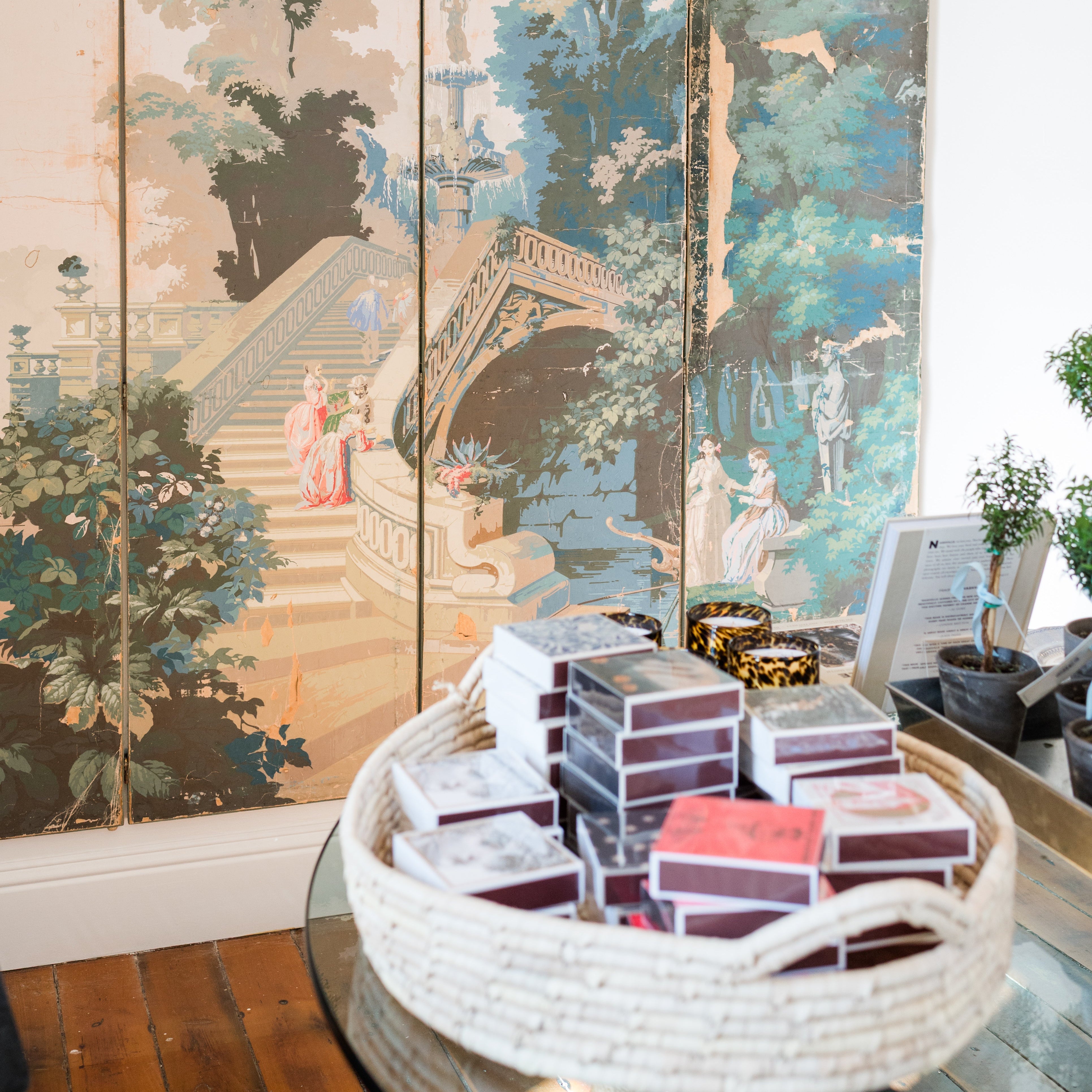 Decorative screen with classical landscape design in a room setting.